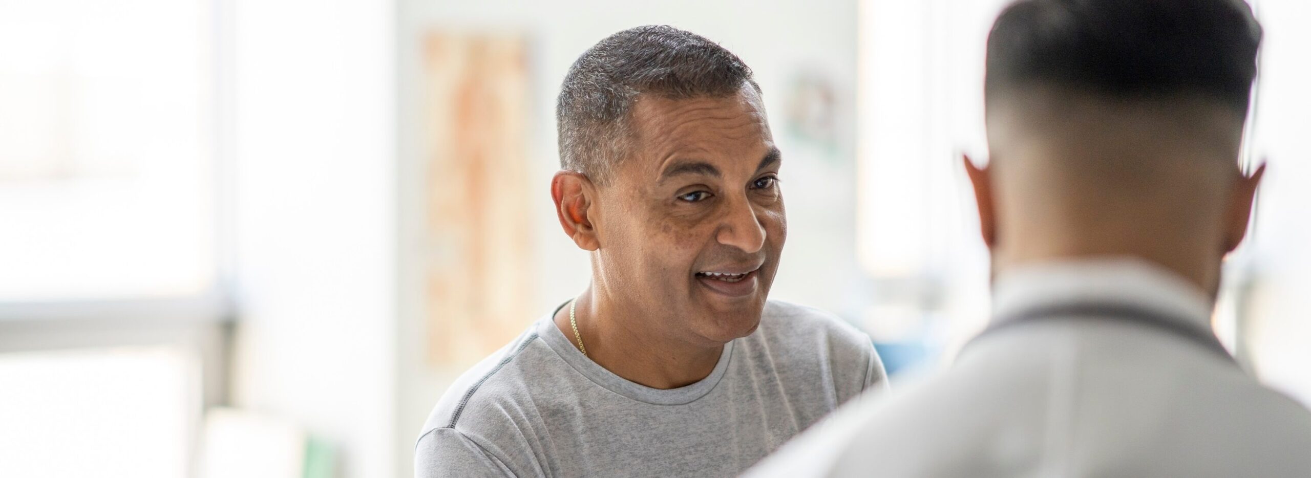 Hopeful male patient meeting with a doctor