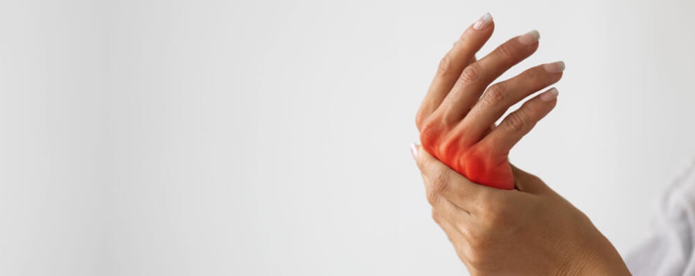 Female hands - left hand massaging the right hand