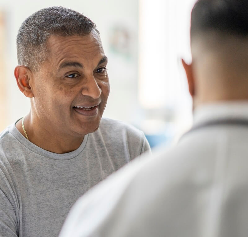 Hopeful male patient meeting with a doctor